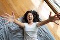 Beautiful young brunette girl fooling around on the bed. View from above. Good mood Royalty Free Stock Photo