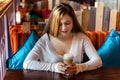 Young woman sitting in cafe Royalty Free Stock Photo