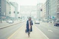 Beautiful young brunette posing in the city streets