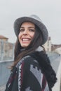 Beautiful young brunette posing in the city streets