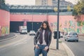 Beautiful young brunette posing in the city streets