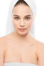 Beautiful young brunette woman with clean face and towel on her head. Isolated. Royalty Free Stock Photo