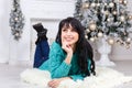 Beautiful young brunette woman lies on the floor indoors in a ch Royalty Free Stock Photo