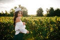 Beautiful young brunette woman on the meadow with white flowers on a warm summer day Royalty Free Stock Photo