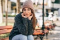 Beautiful young brunette woman smiling broadly, wearing eyeglasses, knitted sweater and hat. Outdoor portrait of pretty female Royalty Free Stock Photo