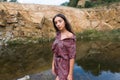 Beautiful young brunette woman in summer dress enjoying in meadow nature Royalty Free Stock Photo