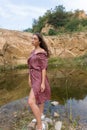 Beautiful young brunette woman in summer dress enjoying in meadow nature Royalty Free Stock Photo