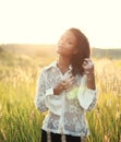 Beautiful young brunette woman with vitiligo disease on the field with beautiful sunset Royalty Free Stock Photo