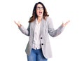 Beautiful young brunette woman wearing business clothes and glasses crazy and mad shouting and yelling with aggressive expression Royalty Free Stock Photo