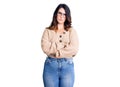 Beautiful young brunette woman wearing casual clothes and glasses skeptic and nervous, disapproving expression on face with Royalty Free Stock Photo