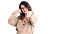 Beautiful young brunette woman wearing casual clothes and glasses smiling doing talking on the telephone gesture and pointing to Royalty Free Stock Photo