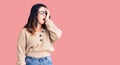 Beautiful young brunette woman wearing casual clothes and glasses yawning tired covering half face, eye and mouth with hand Royalty Free Stock Photo