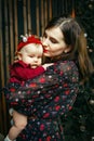 A beautiful young brunette woman holds in her arms a charming little girl. Love and care for the child Royalty Free Stock Photo