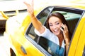 Beautiful young business female talking on cell phone in taxi Royalty Free Stock Photo