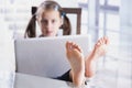 Beautiful young business girl working in office, feet on desk. Selective focus on feet Royalty Free Stock Photo