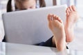 Beautiful young business girl working in office, feet on desk. Selective focus on feet. Copy space Royalty Free Stock Photo
