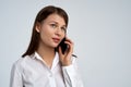 Beautiful young business lady woman in white shirt with serious expression talking on the phone. Close-up Royalty Free Stock Photo