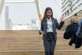 Beautiful young business man walked down the stairs and raised his hand to greet his friend in modern city. Copy space Royalty Free Stock Photo