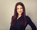 Beautiful young business toothy smiling woman thinking and looking happy on blue grey background with empty copy space. Portrait Royalty Free Stock Photo