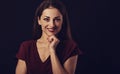 Beautiful young business toothy smiling woman thinking and looking happy in burgundy blouse and with red lipstick on dark shadow Royalty Free Stock Photo