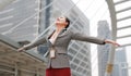 Beautiful young business woman feeling free with arms wide open outside Royalty Free Stock Photo