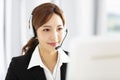 Beautiful young business woman operator in headset Royalty Free Stock Photo