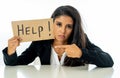 Beautiful young business woman overwhelmed and tired holding a help sign Royalty Free Stock Photo