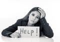 Beautiful young business woman overwhelmed and tired holding a help sign Royalty Free Stock Photo