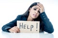 Beautiful young business woman overwhelmed and tired holding a help sign Royalty Free Stock Photo