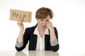 Beautiful young business woman overwhelmed and tired holding a help sign Royalty Free Stock Photo