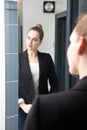 Beautiful young business woman preparing herself for confident morning routine Royalty Free Stock Photo