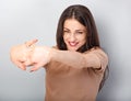 Beautiful young business woman relaxing and stretching in beige blouse on blue background. Portriat closeup healthy