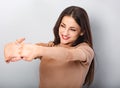 Beautiful young business woman relaxing and stretching in beige blouse on blue background. Portriat closeup healthy