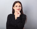 Beautiful young business woman thinking and looking up on blue background Royalty Free Stock Photo