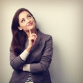 Beautiful young business woman thinking and looking up Royalty Free Stock Photo