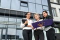 Beautiful and young business women with documents and folders posing outside office building Royalty Free Stock Photo