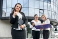 Beautiful and young business women with documents and folders posing outside office building Royalty Free Stock Photo