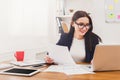 Beautiful young businesswoman sitting by office desk with laptop Royalty Free Stock Photo