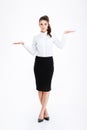 Beautiful young businesswoman standing and holding copyspace on both palms Royalty Free Stock Photo