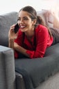 Beautiful, young businesswoman using a phone on a sofaBeautiful young businesswoman talking over the phone on a sofa Royalty Free Stock Photo