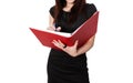 Portrait of beautiful young businesswoman writing notes in folder over white background Royalty Free Stock Photo