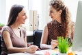 Beautiful young businesswomen are discussing new project Royalty Free Stock Photo