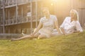 Beautiful young businesswomen relaxing on office lawn