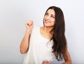 Beautiful young casual cute smiling woman on blue background looking up and thinking. Closeup portrait Royalty Free Stock Photo