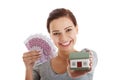 Beautiful young, casual woman holding money and house. Royalty Free Stock Photo