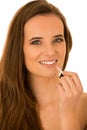 Beautiful young caucasian brunette woman applying lip gloss on h Royalty Free Stock Photo