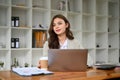 Beautiful young caucasian businesswoman sitting at her desk, looking away from camera Royalty Free Stock Photo
