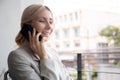 Beautiful young caucasian businesswoman sitting and talking on smartphone with relax in the office. Royalty Free Stock Photo