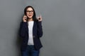 Beautiful young caucasian businesswoman studio shot on grey background Royalty Free Stock Photo