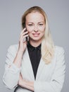 Beautiful young caucasian businesswoman talking on mobile phone. Royalty Free Stock Photo